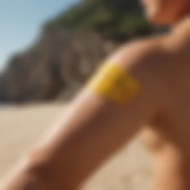 Close-up of a hand applying sun balm sunscreen on an arm with a sandy beach in the background.