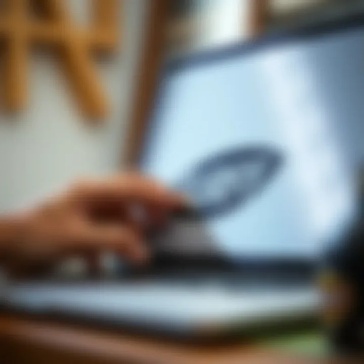 Close-up of a hand applying a surf company sticker on a laptop