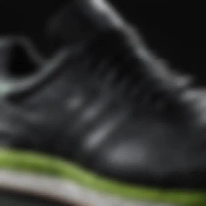 Close-up of black and green Adidas sneaker details