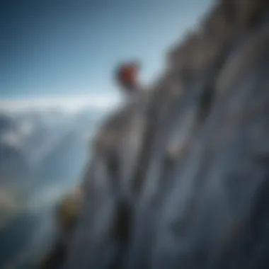 An adventurous climber scaling a rugged cliff face against a clear blue sky at Mont Blanc.