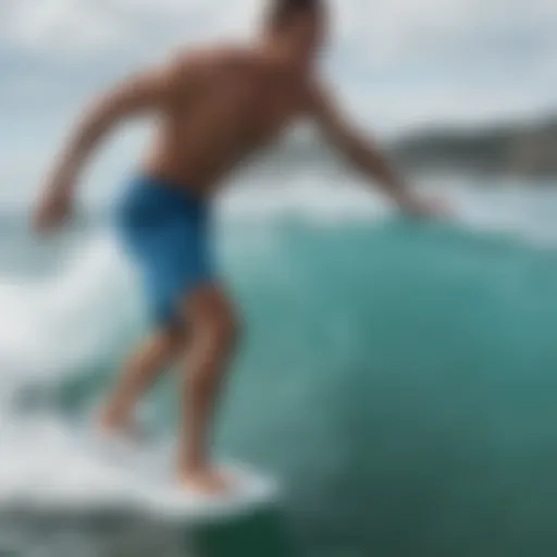 Dynamic athlete showcasing light blue board shorts during an intense surf session.
