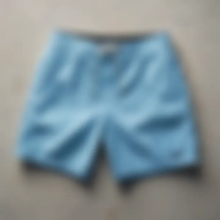 Close-up of light blue board shorts highlighting innovative material and design features.