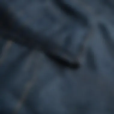 Close-up of the fabric and stitching of blue chinos