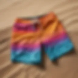 Colorful surfing swim shorts displayed on a sandy beach