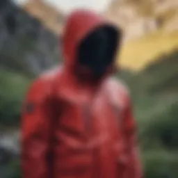 Vibrant red hooded jacket displayed against a rugged outdoor backdrop