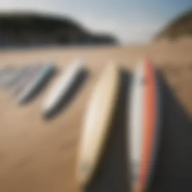 Close-up of surfboards lined up on the beach