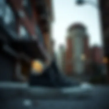 Side view of black on black Converse low tops against an urban backdrop