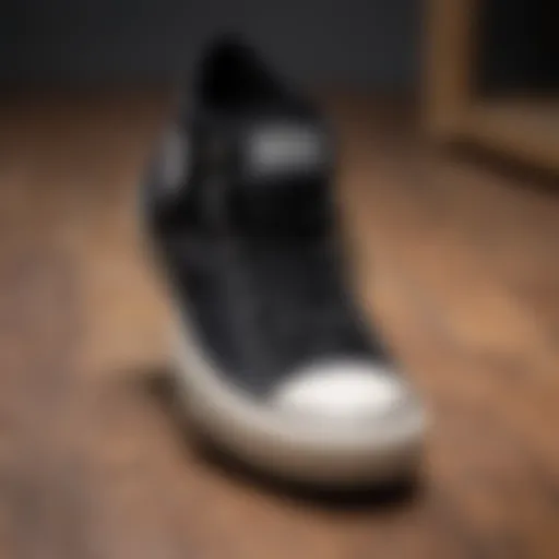 Classic Converse All Star Black sneakers on a wooden surface
