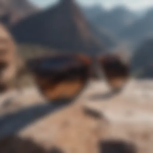 A close-up view of stylish wayfarer-like sunglasses resting on a rocky surface during an extreme sports event