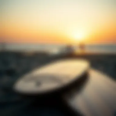 A serene sunset view with skimmer boards resting on the sand