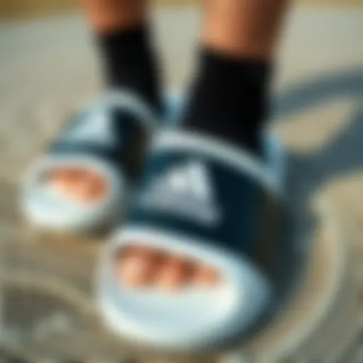 Adidas Slides Design Details Adidas black and white slides on a textured surface