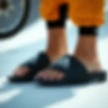 Slides in Action: Extreme Sports Adidas black and white slides worn in an extreme sports setting