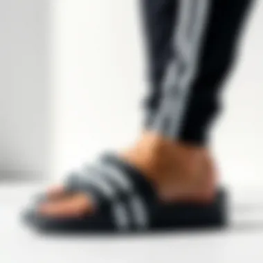 Aesthetic Appeal of Adidas Slides Stylish arrangement of Adidas black and white slides against a minimalist backdrop