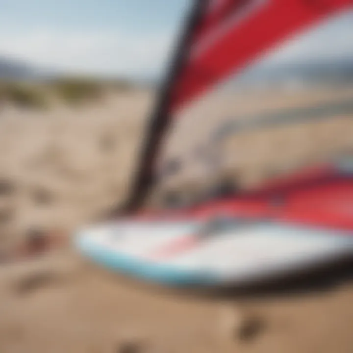 A close-up of windsurfing gear on the sandy shore