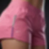 Close-up view of pink Nike tech shorts showcasing design details