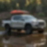 Toyota Tacoma equipped with a paddle board rack at a scenic lake