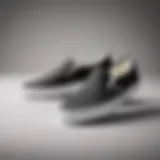 Classic black and white Vans Slip-Ons against a minimalist backdrop