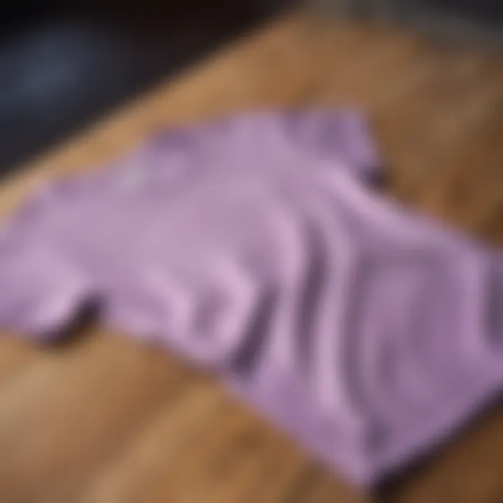 Elegant lilac t-shirt draped over a wooden surface