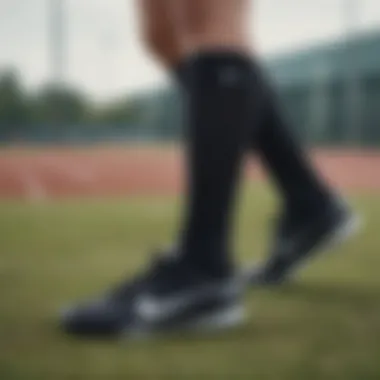 Nike black socks paired with athletic footwear on a sports field