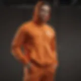 Vibrant display of the orange Nike sweat suit emphasizing its sleek design and color