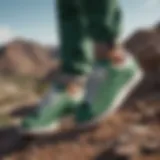 A close-up of Stan Smith Green sneakers on a rugged terrain, symbolizing their connection to extreme sports.