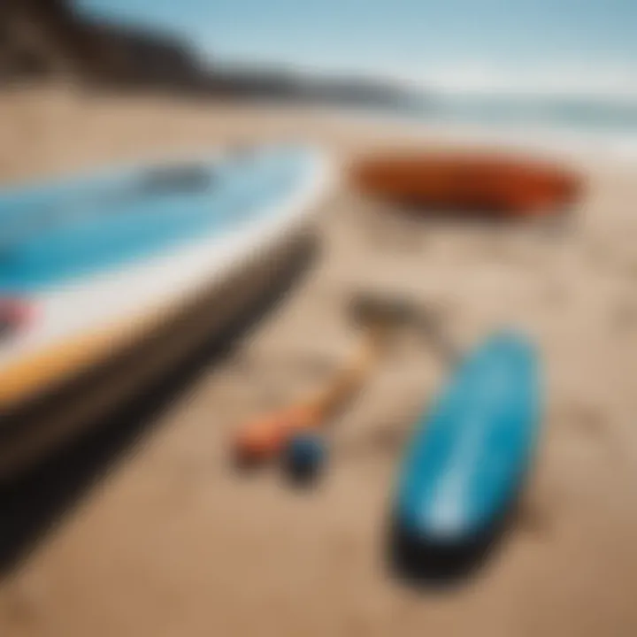 Close-up of paddle and board resting on a sandy beach, emphasizing the gear used in SUP