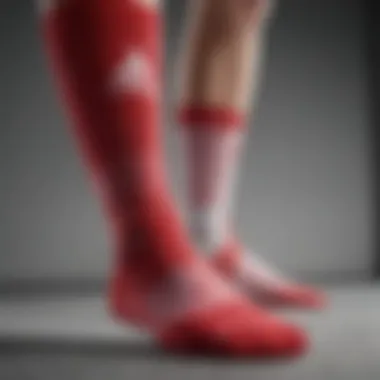 Close-up of red and white Adidas socks highlighting fabric texture and design