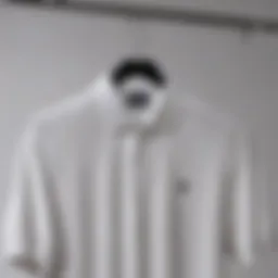 A timeless solid white polo shirt displayed on a stylish hanger