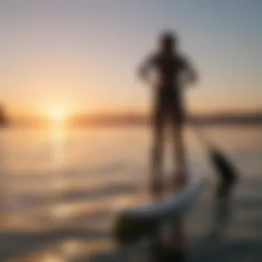 A serene scene of paddle boarding on calm waters during sunset.