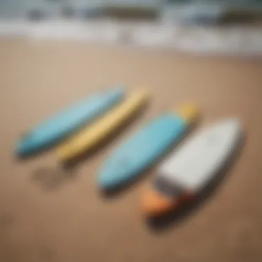 A collection of various small foam surfboards displayed on the beach.